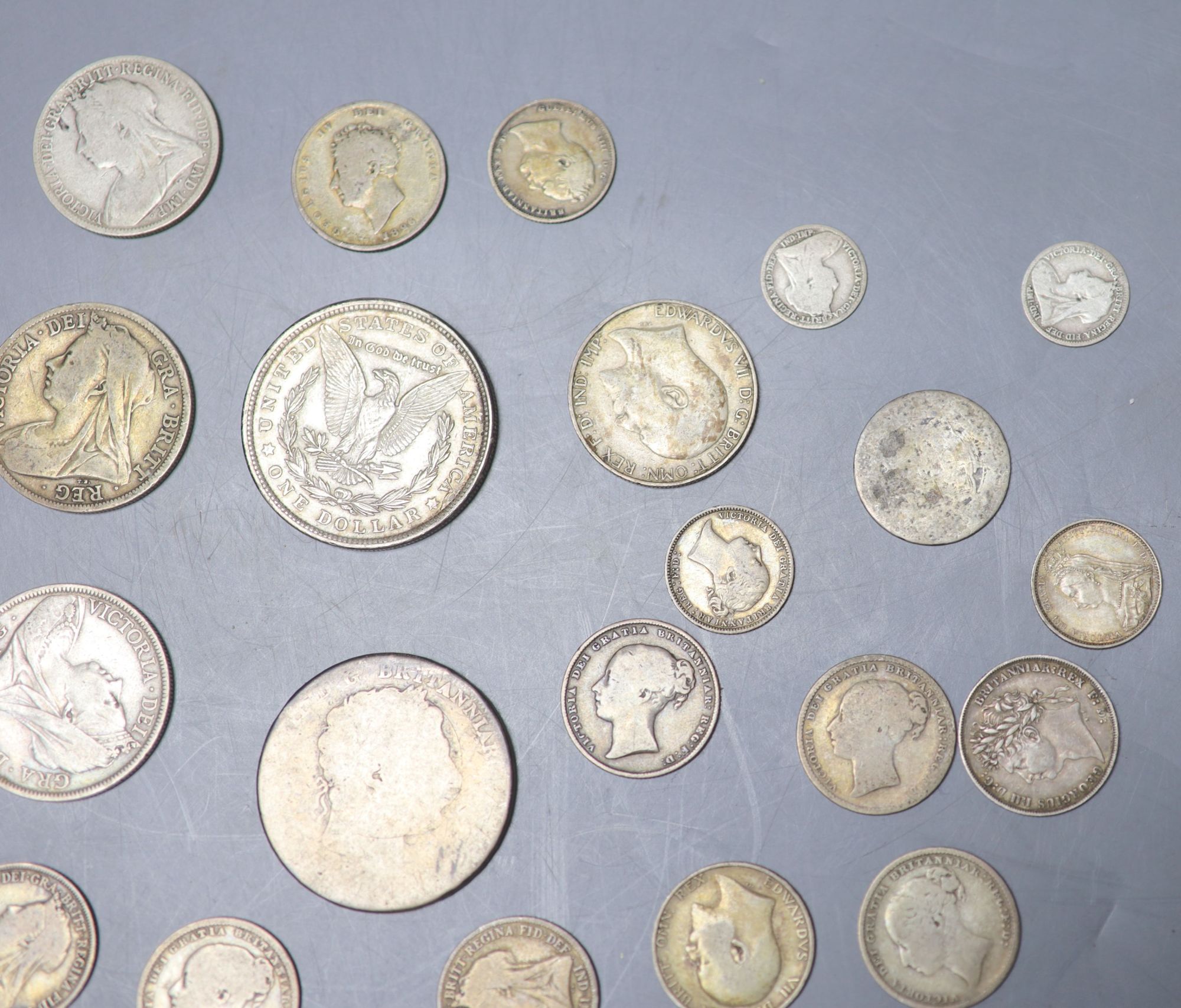 A collection of UK and world coins including George IV - George V silver threepences to halfcrowns